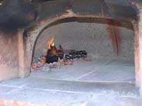 A hot pizza oven's walls turn white, and then you sweep the fire aside