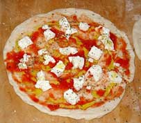 Top the dough with tomato, mozzarella, olive oil, and oregano and you have a pizza ready for the oven